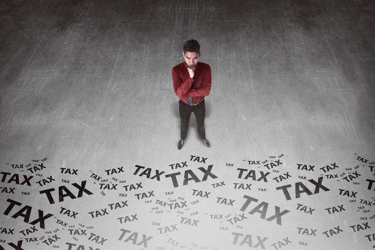 business man looking tax writing