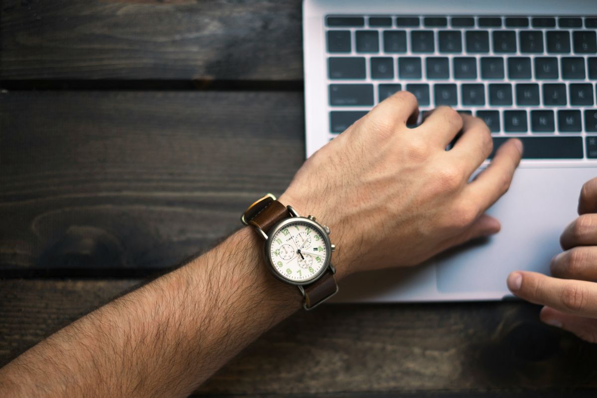 Business owner checking his watch as part of time management