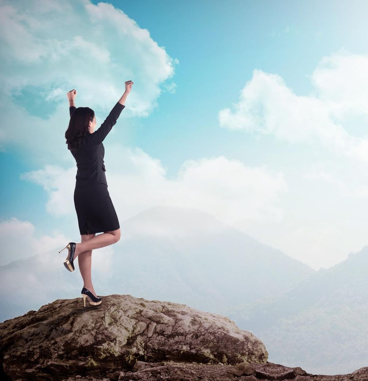 business woman with arms raised