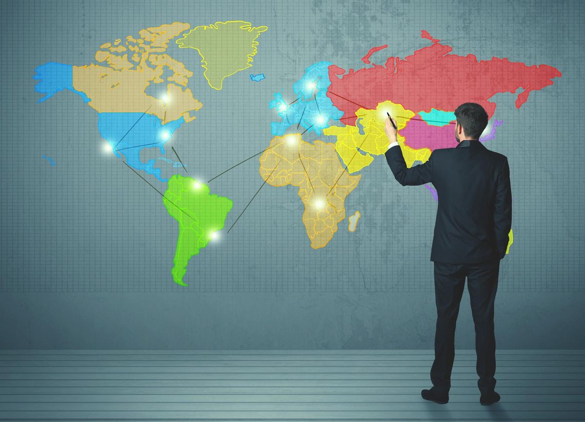 businessman drawing map on wall