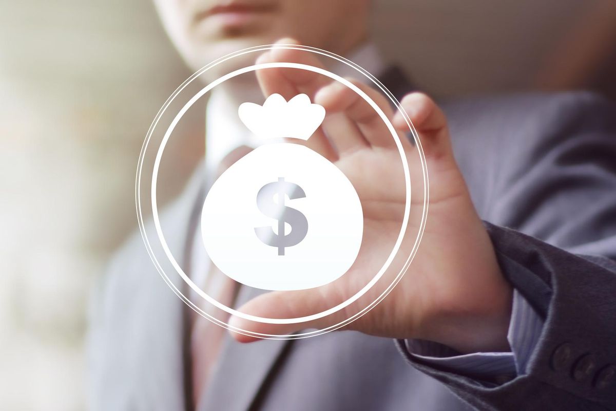 Businessman pushing button with dollar sign