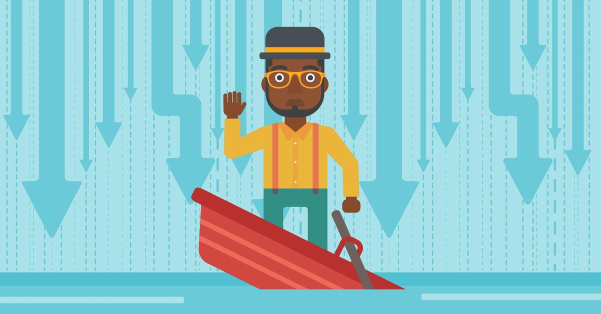 Businessman standing in sinking boat.