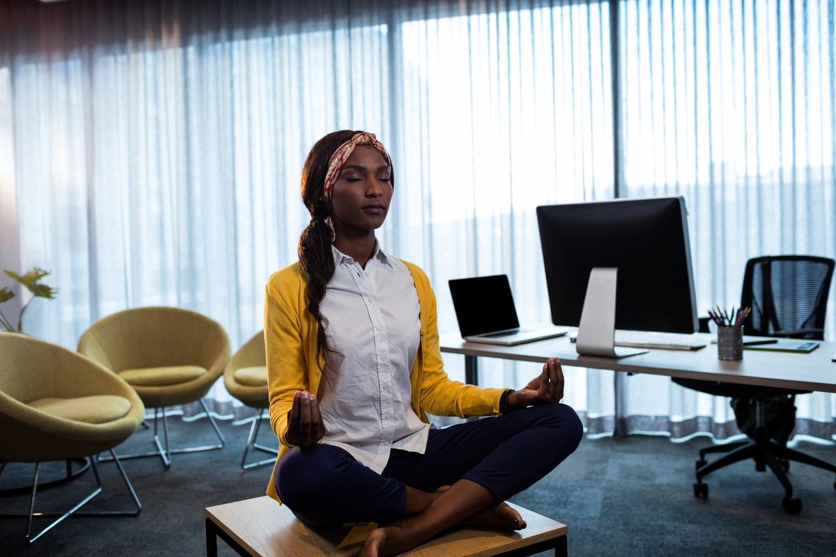 Businesswoman doing yoga