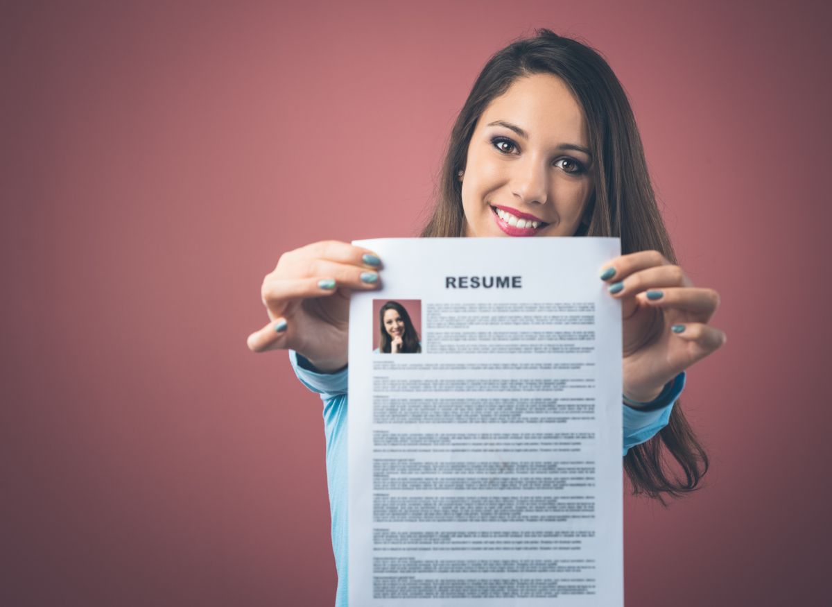 Candidate holding her resume containing the key elements