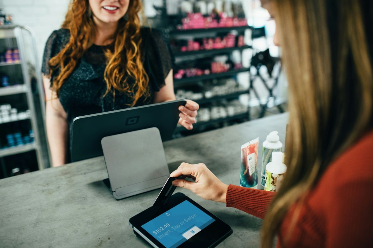 Cashier providing customer service during checkout