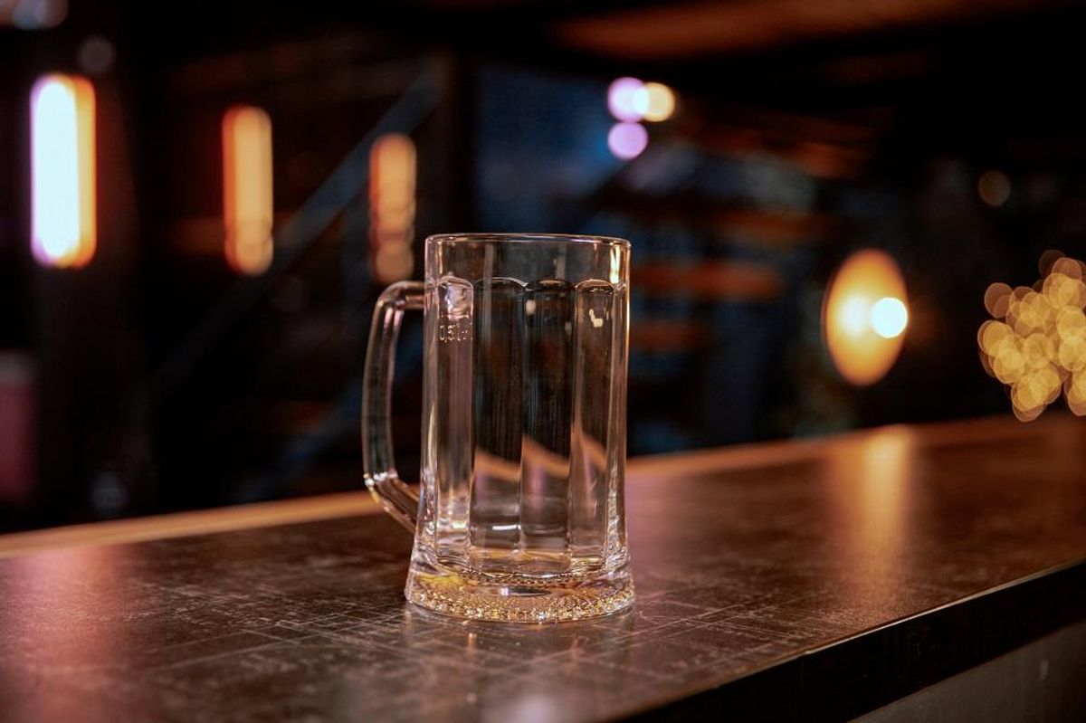 Empty pint lager on wooden table