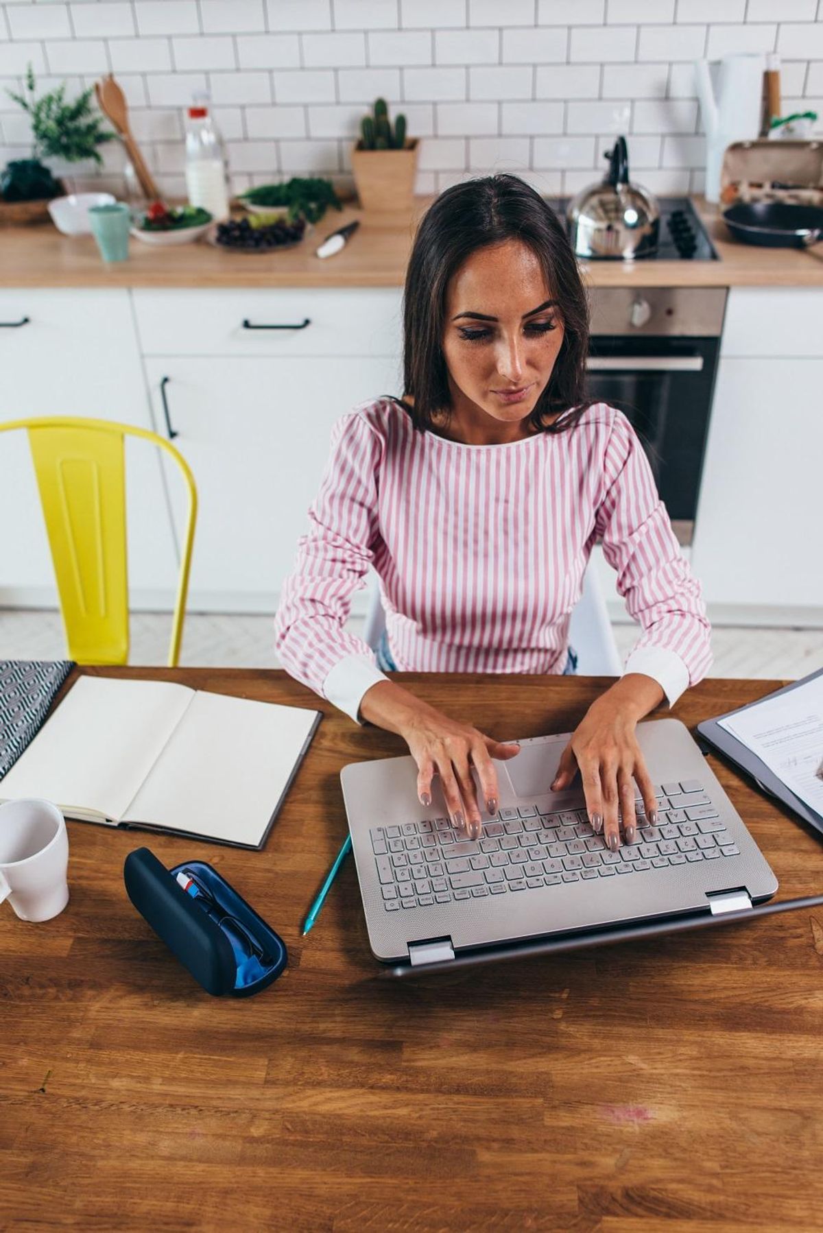 Female freelancer work on laptop computer at home. Top view