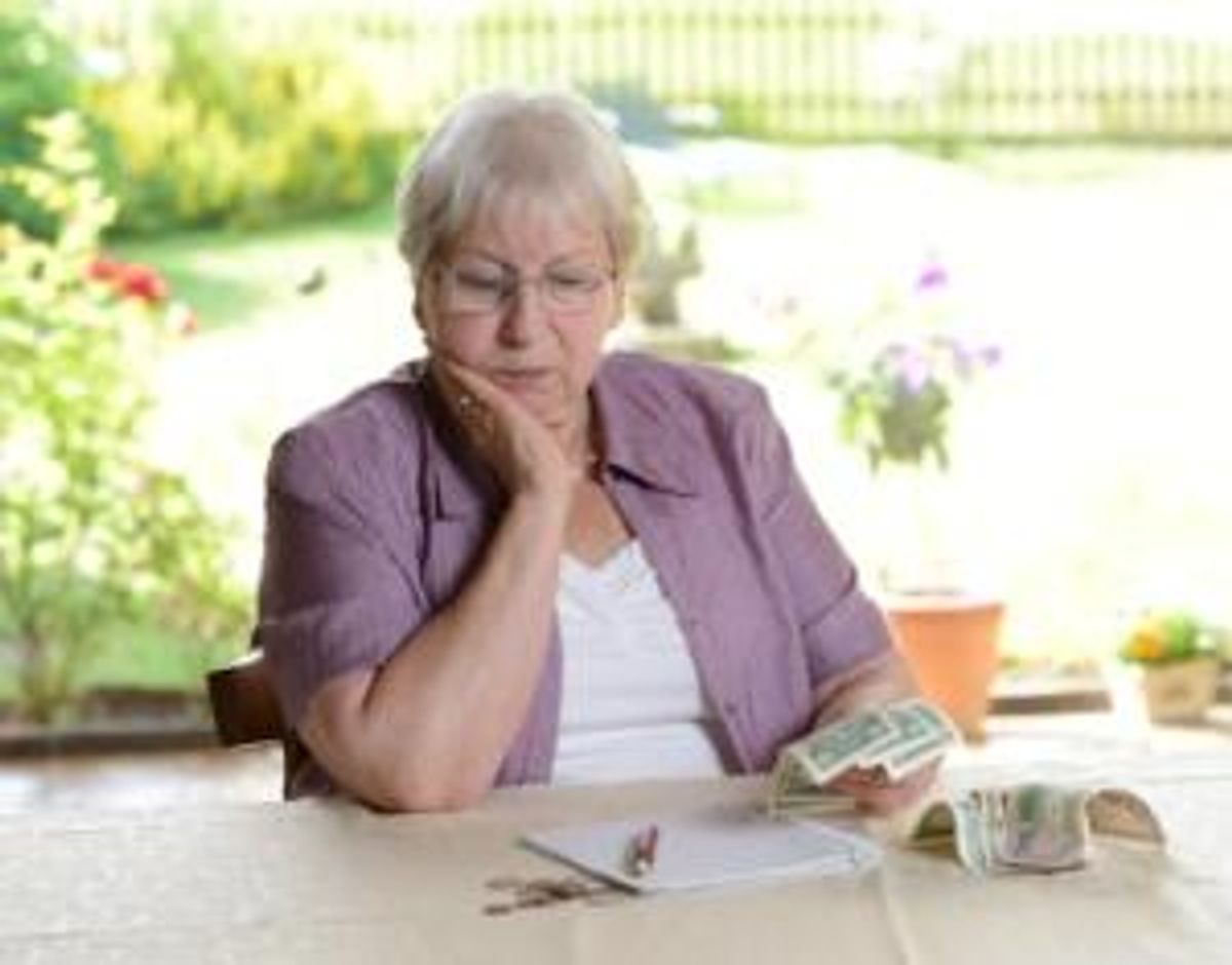female senior is calculating her little budget