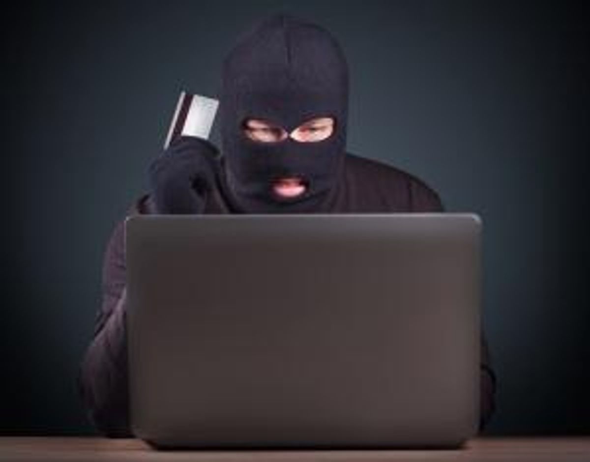 Hacker holding a credit card