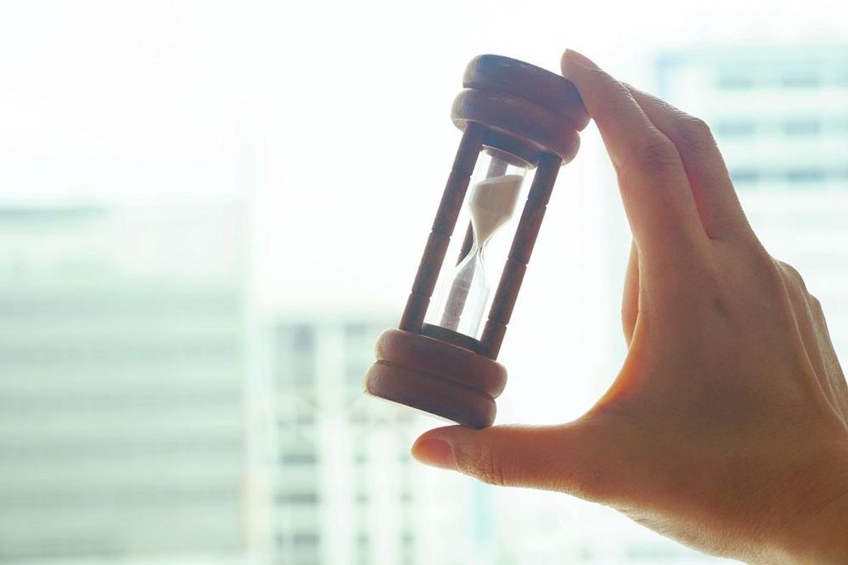 Hand hold hourglass