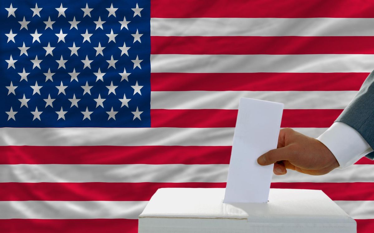 man voting on elections in America in front of flag