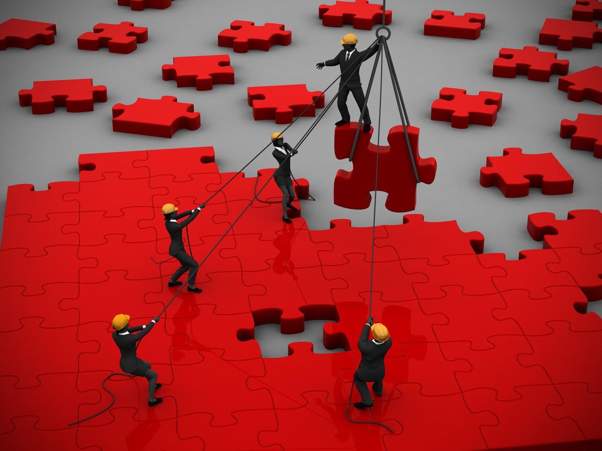puzzle being built by teamwork