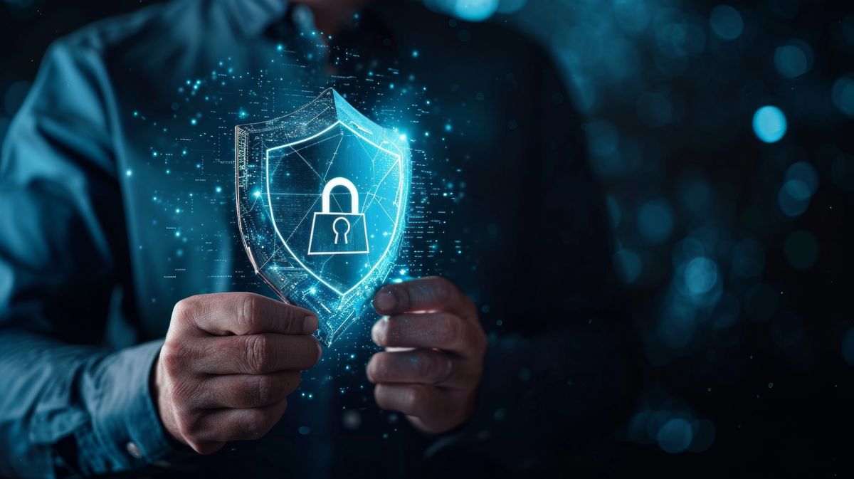 Remote worker holding a cybersecurity symbol