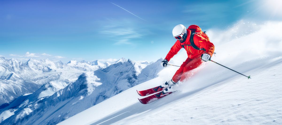 Skier skiing downhill at a ski resort in winter.