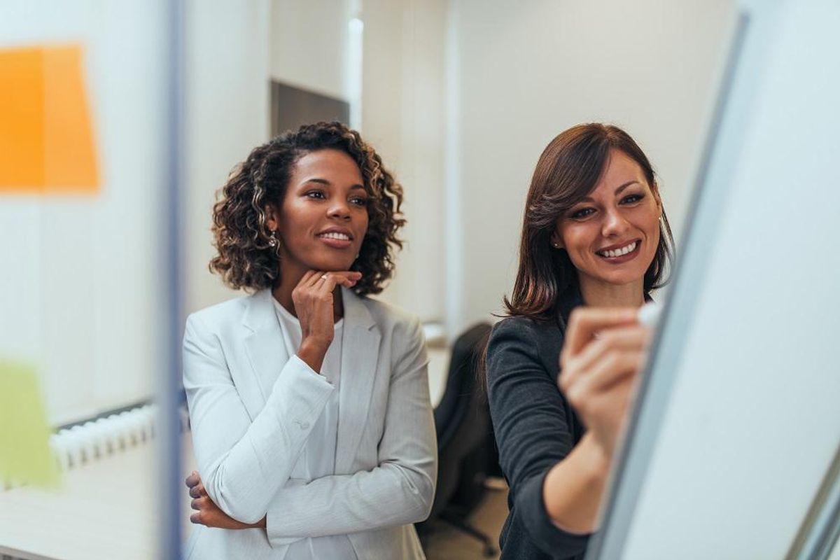 Smiling entrepreneurs working together, close-up.