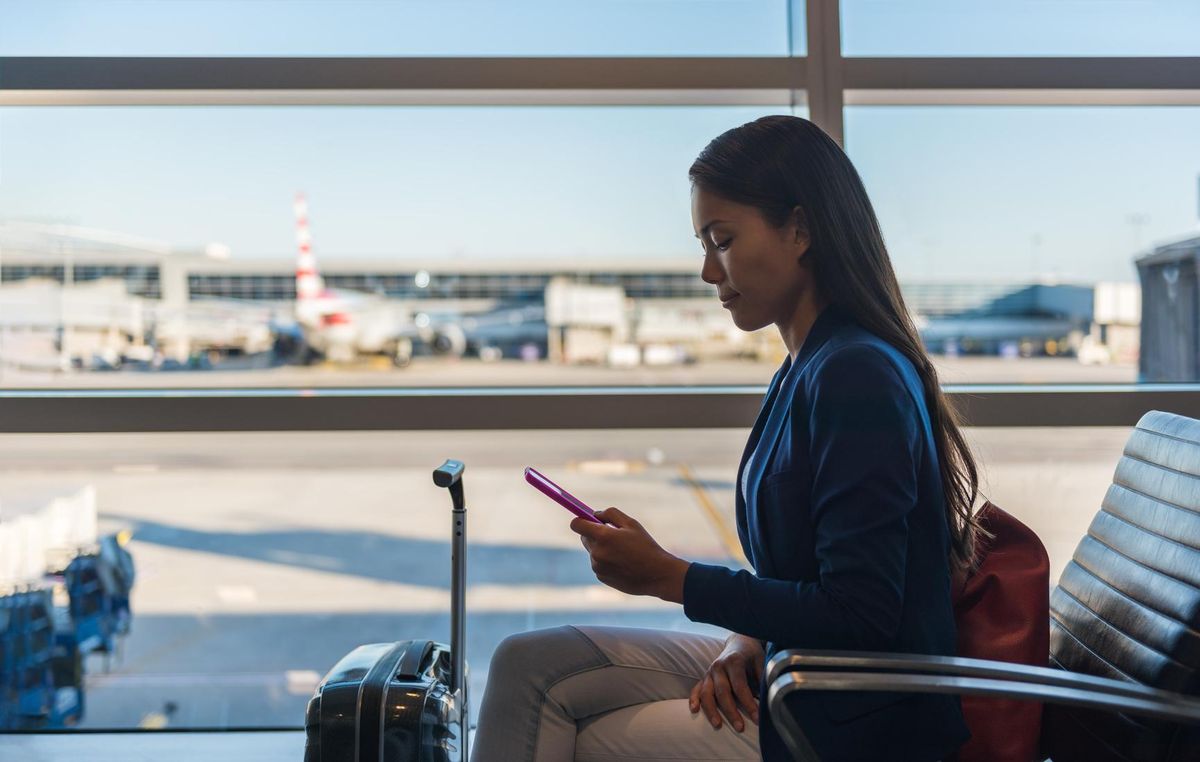 travel woman at airport using mobile
