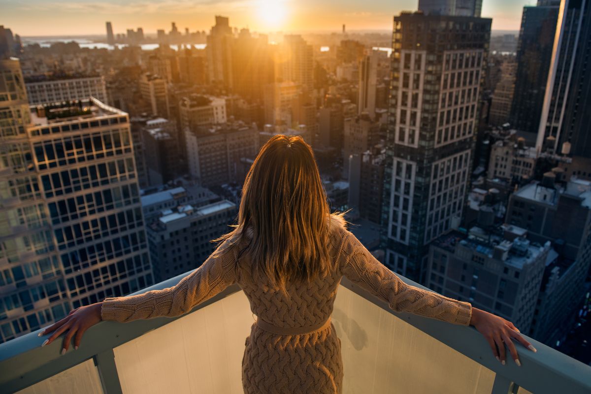 Wealthy woman standing on the balcony